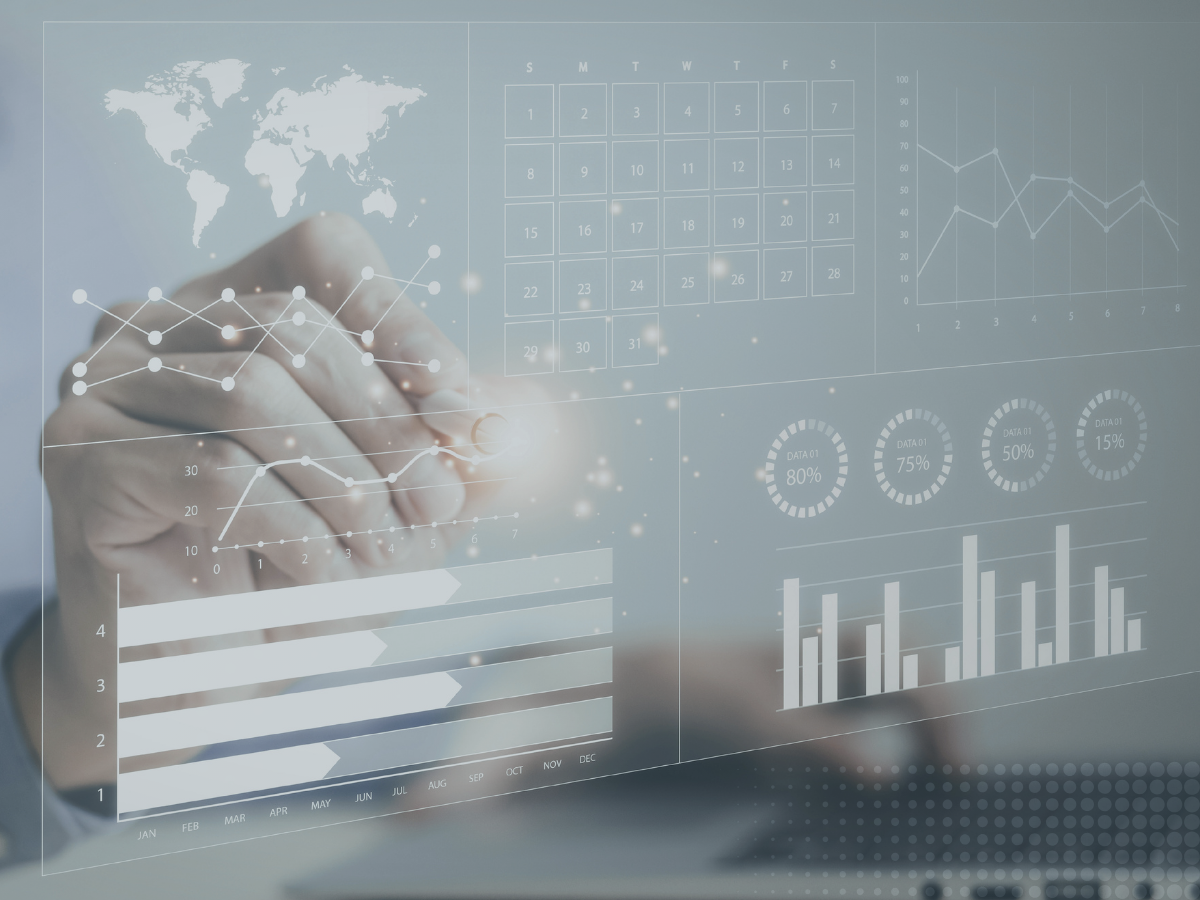 Image of hand behind a screen looking at a detailed metrics dashboard