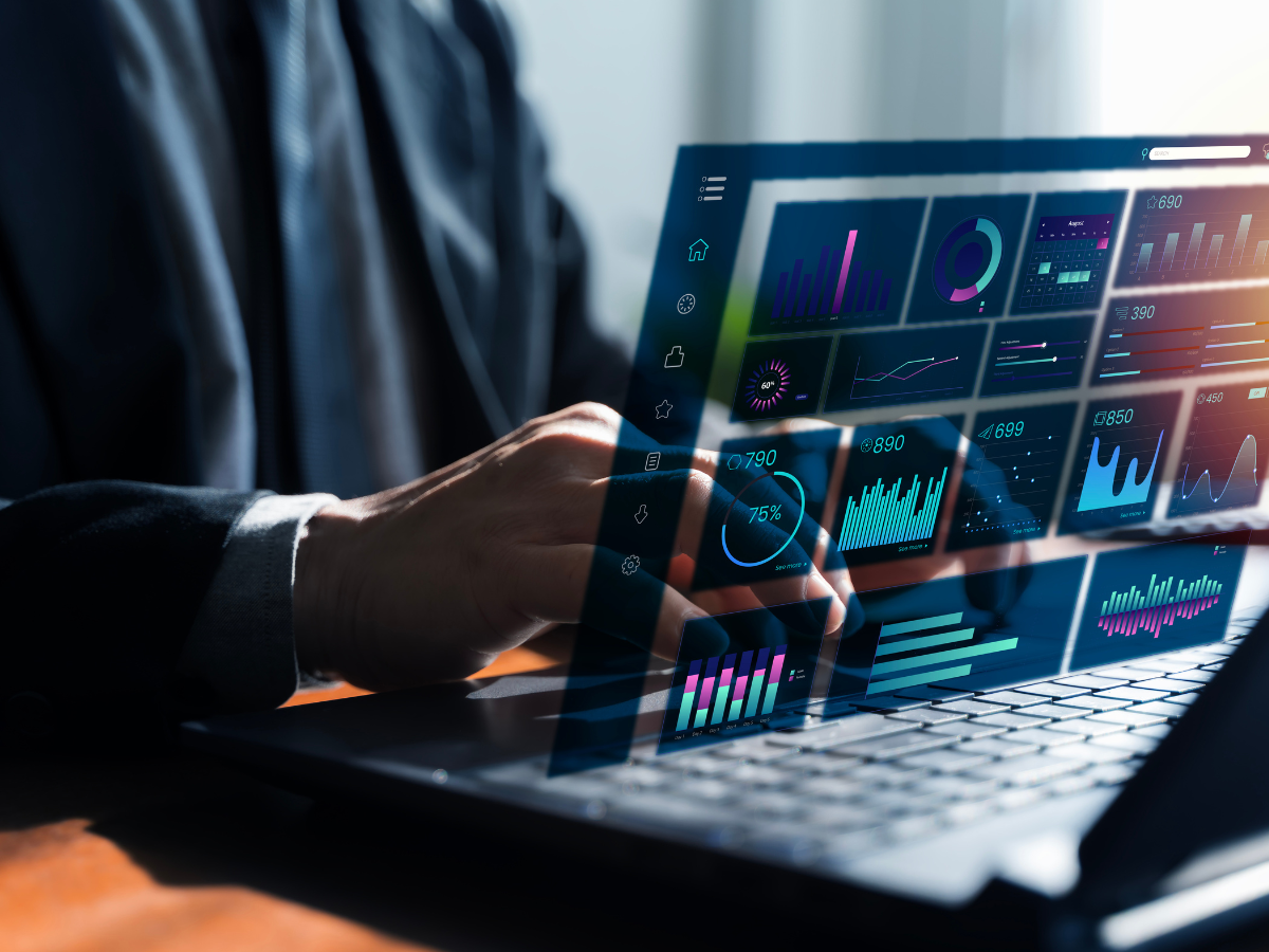 Person using laptop with data visualizations