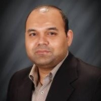 Man in a suit, neutral expression.